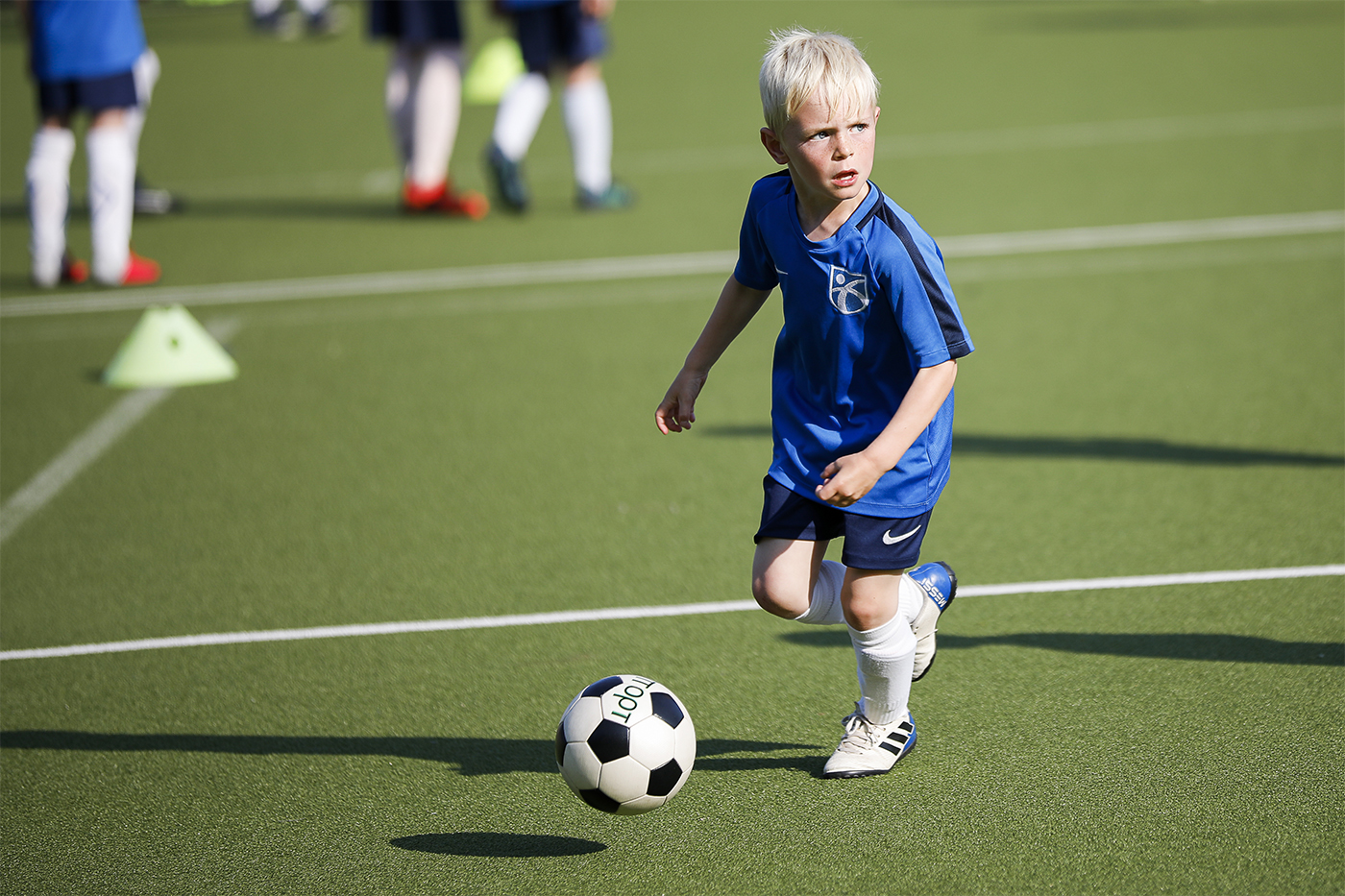 Child preparing to pass football