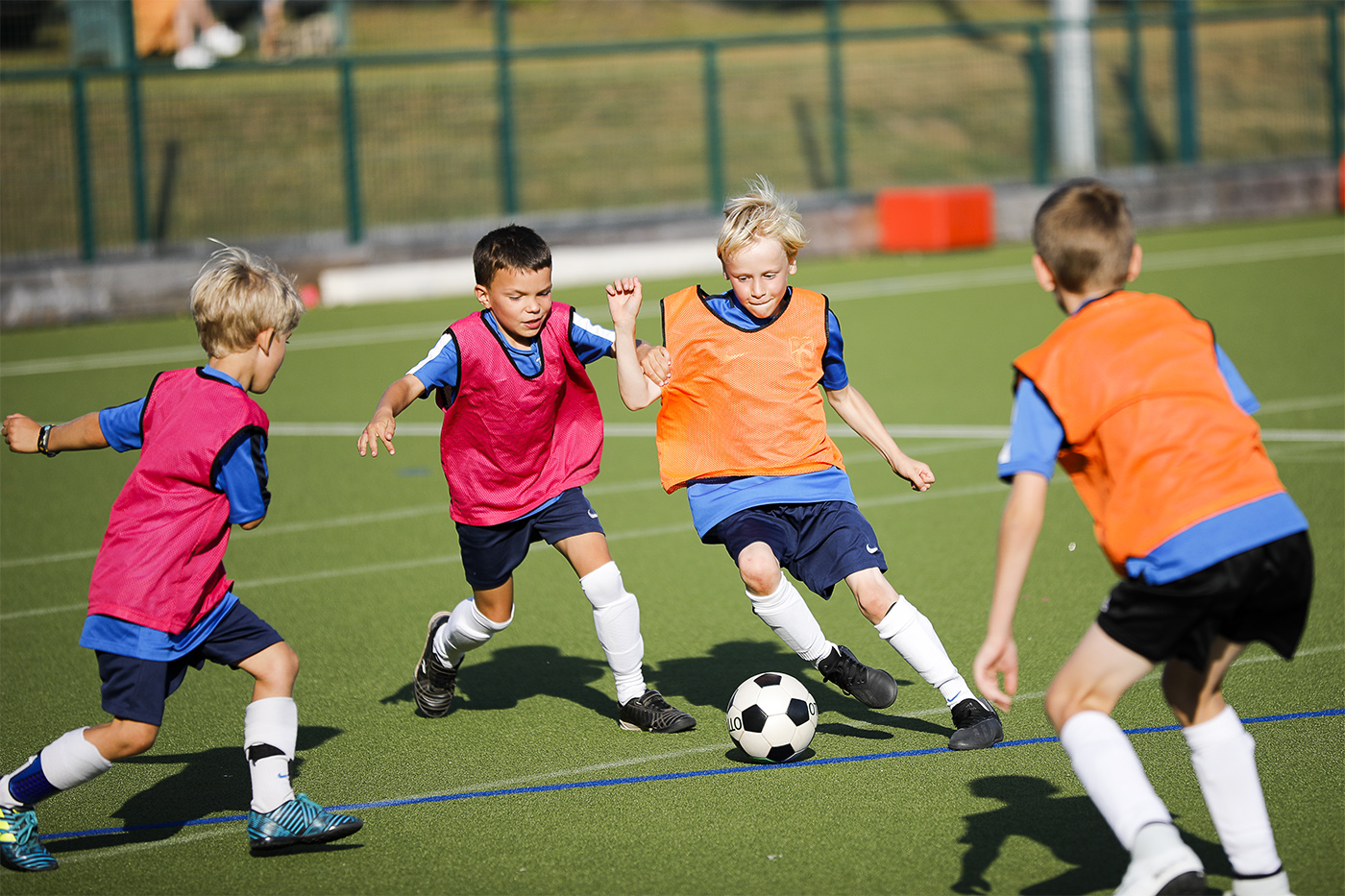 Children dribbling in football