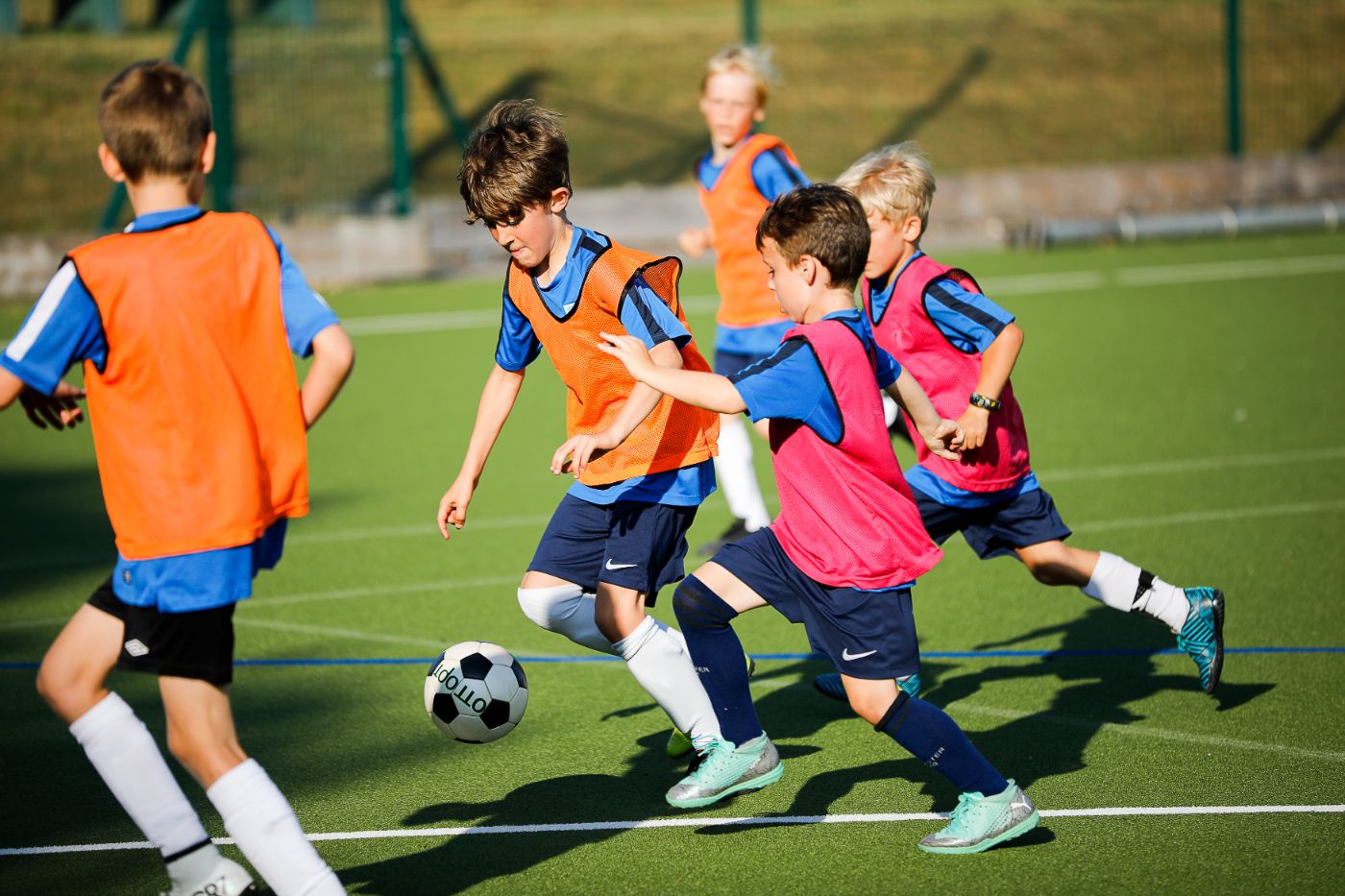 Student running past defenders in football